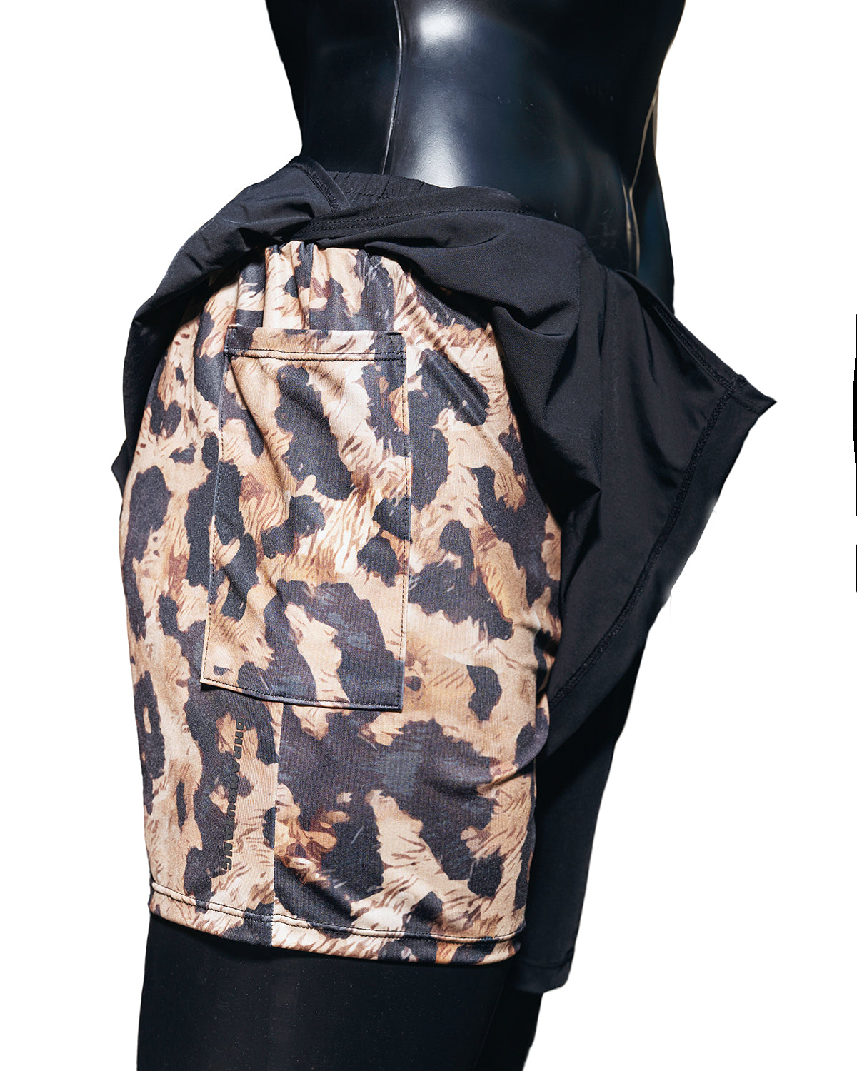 Mannequin in Duku shorts, which feature a Cheetah print inside short and black outer draping short. 