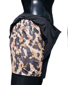Mannequin in Duku shorts, which feature a Cheetah print inside short and black outer draping short. 