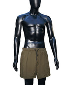A mannequin wearing the Jobari Shorts from Ruin Rally, which feature military green and black outer shorts with a graphic pattern on the inner shorts.
