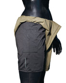 A mannequin wearing the Jobari Shorts from Ruin Rally, which feature military green and black outer shorts with a graphic pattern on the inner shorts.
