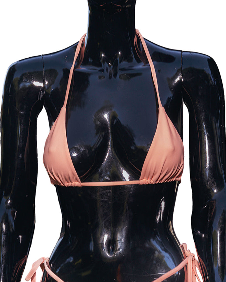 This image features the Aiyana Bikini with a Vivid Peach Top on a Mannequin. The bikini top, in a soft peach hue, is designed with a classic triangle shape that accentuates the curves of the wearer.